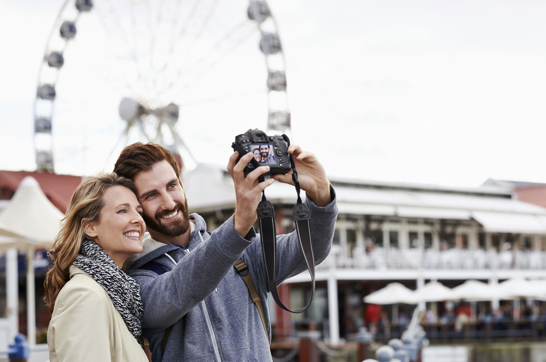 couple in front of a ferris wheel