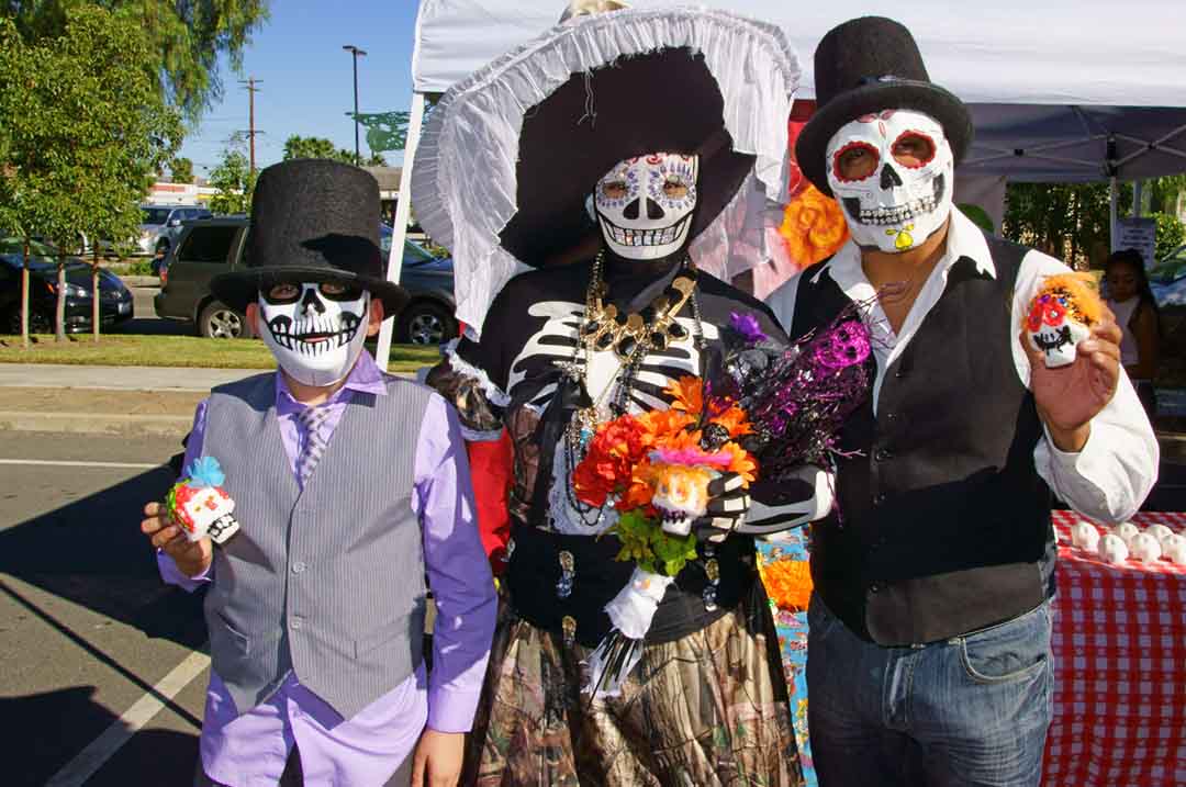 Image a family in costumes celebrating Día de los Muertos - here are some tips on how to enjoy halloween in Los Angeles to the fullest.