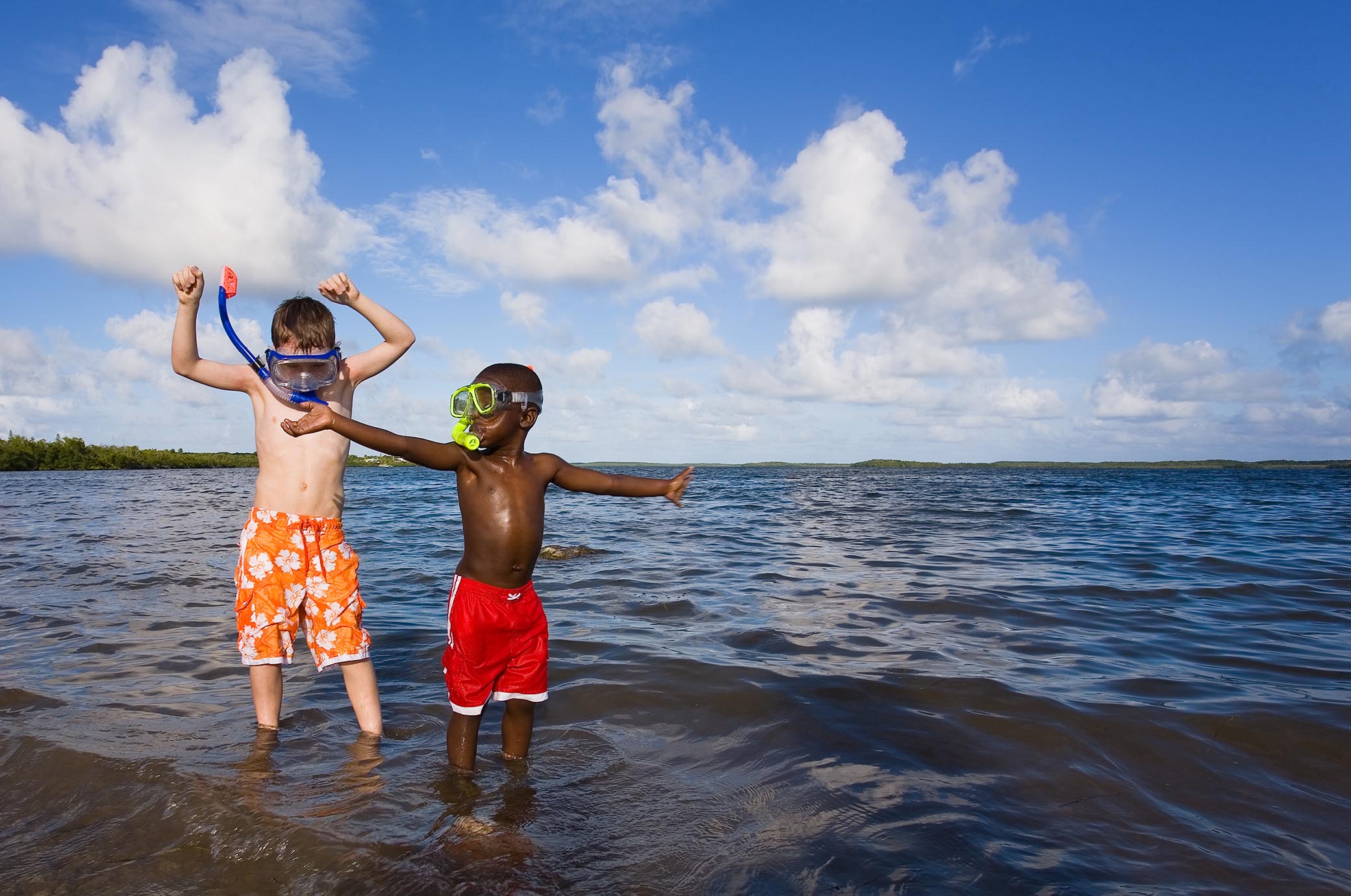 Image of 2 kids playing in the water - traveling with kids. 