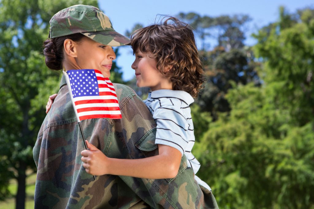 Image of female soldier holding a boy