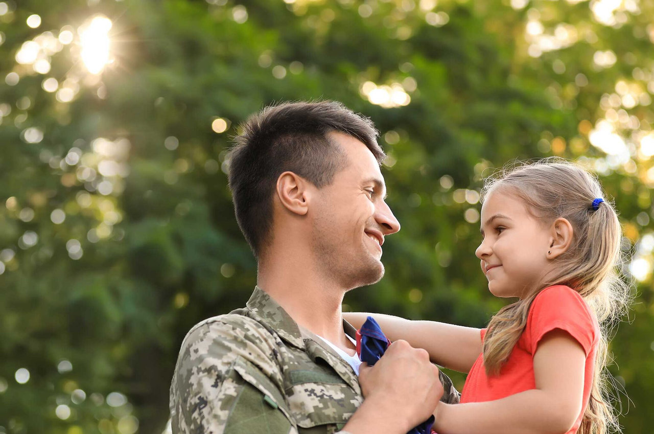 Joyful father holding her daughter