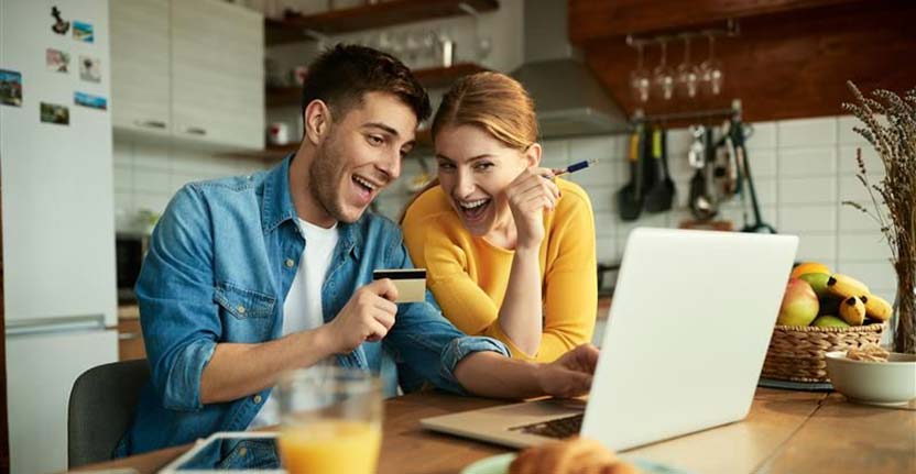 couple at breakfast with laptop