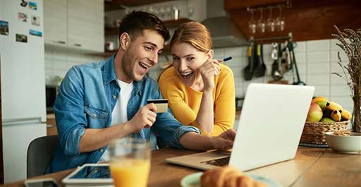 couple at breakfast with laptop