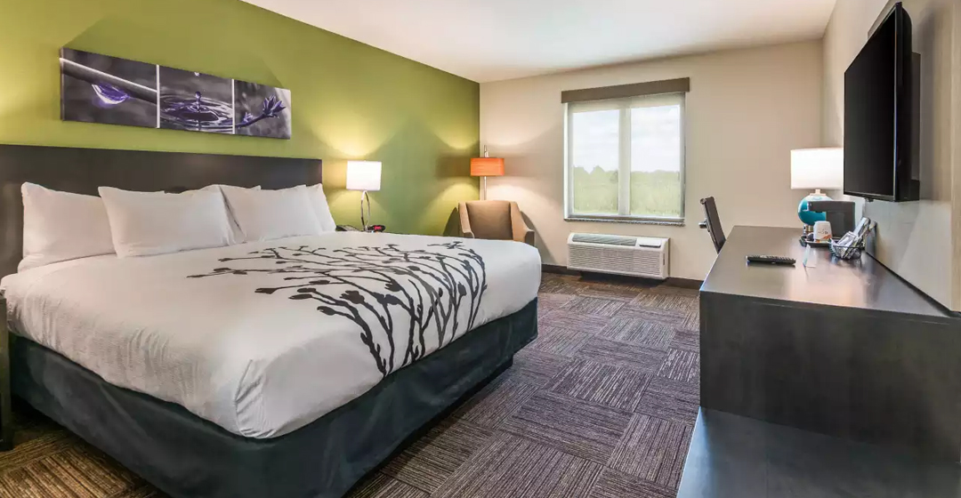 Entrance view of king bed in guest room Sleep Inn Baxley GA