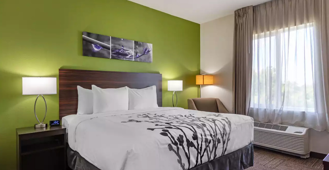 Entrance view of bed in guestroom at Sleep in Tampa South