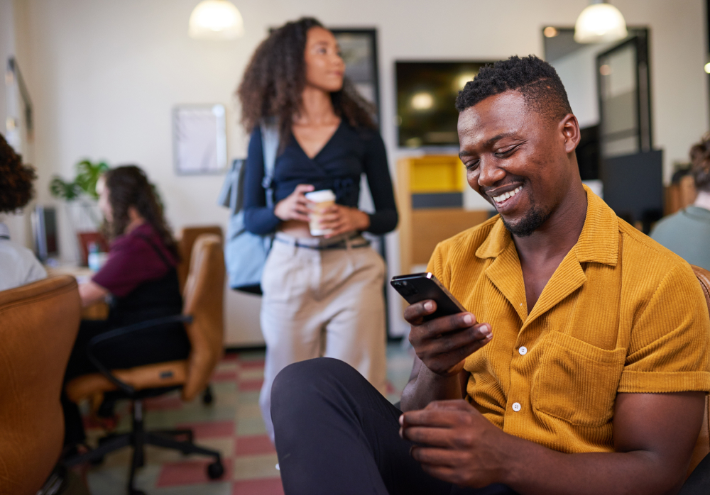 Man smiling looking at phone