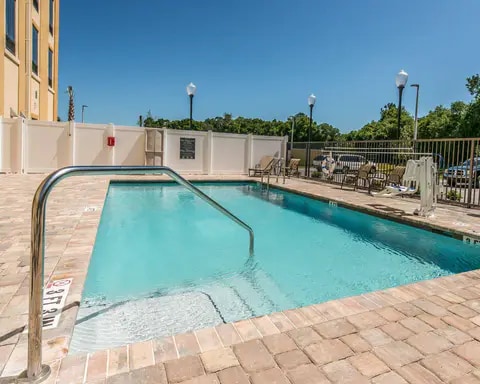 Outdoor pool with sundeck | Comfort Inn Suites Hotel in Dunnellon, FL