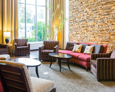 Relax in the open space lobby with club-lounge seating | Cambria hotel and suites, Traverse City