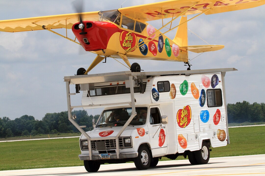 A prop plane sits on top of an RV after landing at one of the best air shows in the U.S.